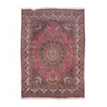 A LARGE SEMI-ANTIQUE PERSIAN RUG, 430 X 310CM, the central field woven with flowerhead medallion