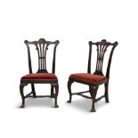 A PAIR OF IRISH MAHOGANY CHAIRS, C.1750, the waved crest rails accentuated with shell corners,