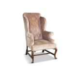 A MID-GEORGIAN STYLE WALNUT FRAMED UPHOLSTERED TALL WING-BACK ARMCHAIR, raised on cabriole legs
