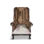 A GEORGE III MAHOGANY WINGBACK ARMCHAIR, on short carved cabriole legs, with heavy carved paw feet