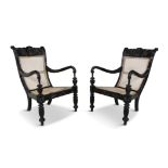 A PAIR OF 19TH CENTURY ANGLO-INDIAN CARVED EBONY SCROLL BACK ARMCHAIRS, the crest rails profusely