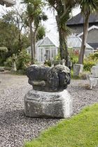 A PAIR OF 18TH CARVED SANDSTONE FIGURES OF CROUCHING LIONS. Each 76cm long, 43cm high