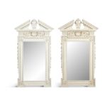 A PAIR OF GEORGIAN STYLE WHITE PAINTED PIER MIRRORS IN THE STYLE IN WILLIAM KENT each with