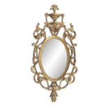 A FINE IRISH GILTWOOD AND GESSO MIRROR, c.1770, the oval plate within a foliate and ribbon pierced