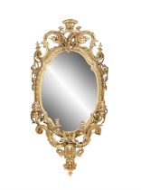 A 19TH CENTURY GILTWOOD GESSO OVAL GIRANDOLE MIRROR, the glass plate contained within a border of