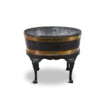 AN OVAL MAHOGANY AND BRASS BOUND WINE COOLER, C.1800 with detachable zinc liner, on a fitted stand