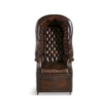 A 20TH CENTURY MAHOGANY FRAMED CHESTERFIELD PORTER'S CHAIR with arched hood, and close-nailed