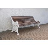 A VICTORIAN CAST IRON GARDEN BENCH, ATTRIBUTED TO COALBROOKDALE with slatted timber back and seat,