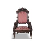 AN IRISH CARVED WALNUT UPHOLSTERED ARMCHAIR, ATTRIBUTED TO ARTHUR JONES OF DUBLIN the padded