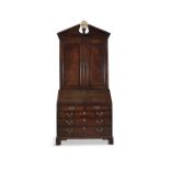 A FINE IRISH GEORGE III FIGURED MAHOGANY BLIND DOOR BUREAU BOOKCASE with an architectural pediment