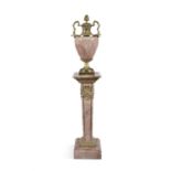 A PINK MARBLE URN ON PILLAR BASE, The urn mounted with gilt metal twin handles and cover on