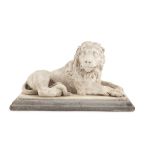 A 19TH CENTURY CARVED WHITE MARBLE FIGURE OF A RESTING LION, on a grey stone platform base. 40 x