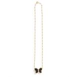 AN ONYX AND DIAMOND BUTTERFLY NECKLACE The butterfly pendant set with a round,