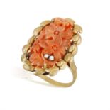 A MID-20TH CENTURY, CARVED CORAL AND DIAMOND RING The coral carved in floral motifs,