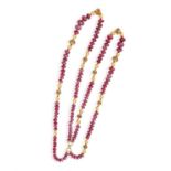 A DOUBLE-ROW SAUTOIR OF RUBY BEADS The double-row of ruby beads with ovoid and spherical spacers,
