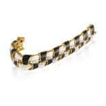 AN 18CT GOLD, BLACK AND WHITE ENAMEL AND DIAMOND BRACELET The interlaced links set with round,