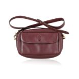 A 'MUST DE CARTIER' CROSSBODY LEATHER HANDBAG AND LEATHER BELT BY CARTIER The bordeaux leather