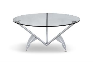 PHILIPPE STARCK (B.1949) A circular glass topped dining table on an aluminium base by Phillipe