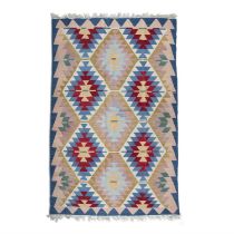 KILIM RUG A flat-woven Kilim rug, decorated with rows of geometric lozenges against a peach