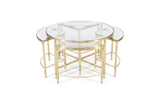 TABLES A circular brass table with a glass top with four additional glass topped tables