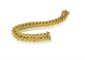 A GOLD BRACELET, ITALIAN, CIRCA 1955 Composed of a textured gold curb-link chain, in 18K gold,