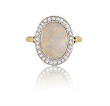 AN EARLY 20TH CENTURY OPAL AND DIAMOND DRESS RING The central oval-shaped opal cabochon within