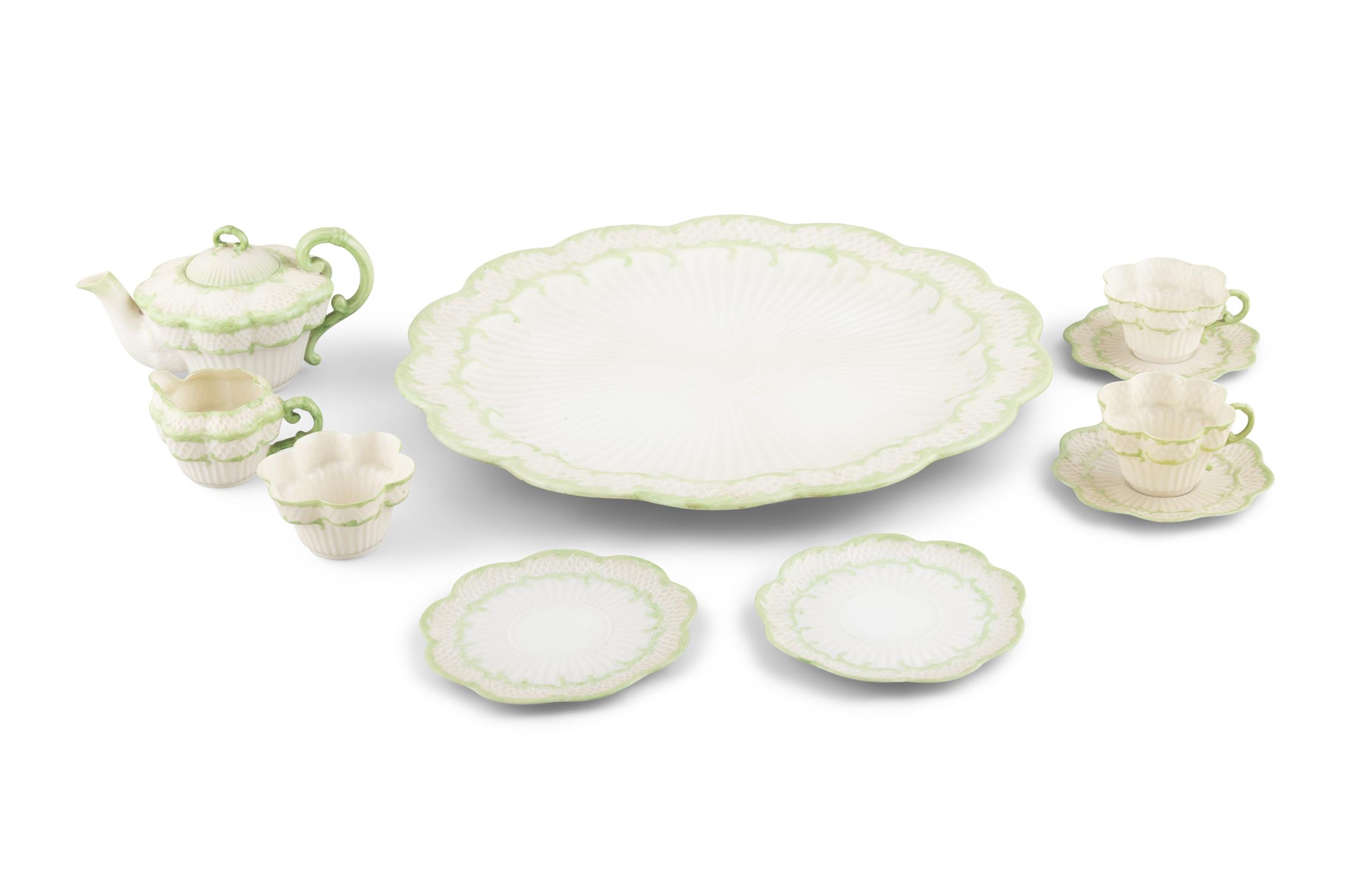 A BELLEEK SECOND PERIOD ERNE PATTERN PART TEA SERVICE decorated with green paint foliate sprays,