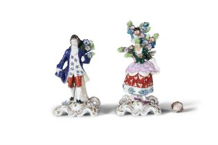 A PAIR OF 19TH CENTURY PORCELAIN FIGURES modelled as a girl and boy standing in a bower.