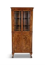 AN EDWARDIAN FIGURED WALNUT CORNER CABINET, C. 1900 the Cavetto cornice above twin crossbanded