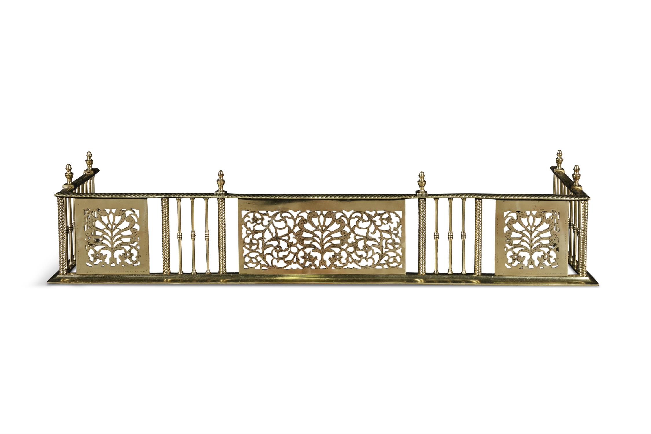 A GEORGE IV PIERCED BRASS CURB FENDER, with spiral reeded top above alternating panels of