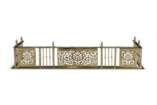 A GEORGE IV PIERCED BRASS CURB FENDER, with spiral reeded top above alternating panels of