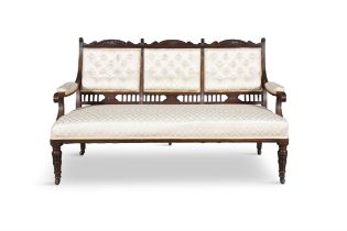 AN EDWARDIAN MAHOGANY FRAMED BUTTON BACK THREE SEATER SETTEE the triple back with pierced frame,