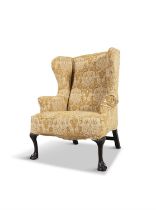 A GEORGIAN STYLE MAHOGANY FRAMED UPHOLSTERED WING-BACK ARMCHAIR, with loose cover,