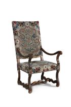 A 17TH CENTURY STYLE FRUITWOOD FRAMED UPHOLSTERED ARMCHAIR, the rectangular panel back and seat