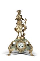 AN ONYX AND GILTMETAL FIGURAL MANTLE CLOCK, C.1900, surmounted by a figure of a girl picking