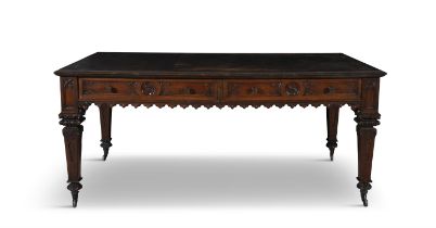 A 19TH CENTURY OAK LIBRARY TABLE, the inset leather top, above carved gothic frieze with twin