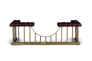 A BRASS CLUB FENDER, the close nailed button seats upholstered in red leather,