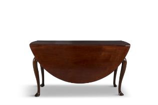 AN IRISH GEORGIAN MAHOGANY DOUBLE DROP LEAF TABLE extending to an oval shape, the solid panel