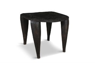 A LARGE AFRICAN TRIBAL STOOL, the dipped seat carved with geometric ornament,