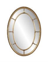 A GITLWOOD OVAL COMPARTMENTAL MIRROR, the outer frame with gadrooning and beading,