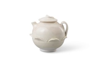 A DING KLINS LOTUS-BUD EWER OF WHITE STONEWARE 五代 定窯白釉浮雕蓮瓣壺 China, Five Dynasties The small ewer