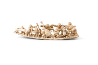 λ AN IVORY OKIMONO, SIGNED GYOKUMIN Japan, Meiji period (1868-1912) depicting a travelling