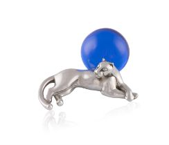 A silver 'panther' paperweight by Cartier The small silver model of a panther leaning on a blue