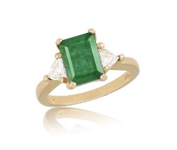 An Emerald and diamond three-stone ring The emerald-cut emerald flanked by two trillion-cut