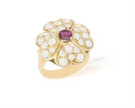 A Ruby and diamond cluster ring Of flowerhead design, the round, mixed-cut ruby centred within