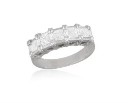 A Diamond five-stone ring Set with five princess-cut diamonds, with a pierced heart-shape to
