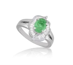 An Emerald and diamond cluster ring The oval-shaped emerald set within a tapered baguette-cut