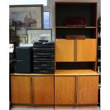 A teak tall wall unit the upper part fitted open shelf above cupboard enclosed by a pair of panel