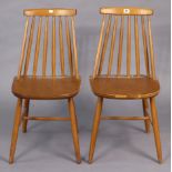 A pair of Ercol? spindle-back kitchen chairs with hard seats, & on round tapered legs with spindle