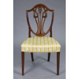 A 19th century mahogany Hepplewhite-style dining chair with carved shield-shaped back, padded seat